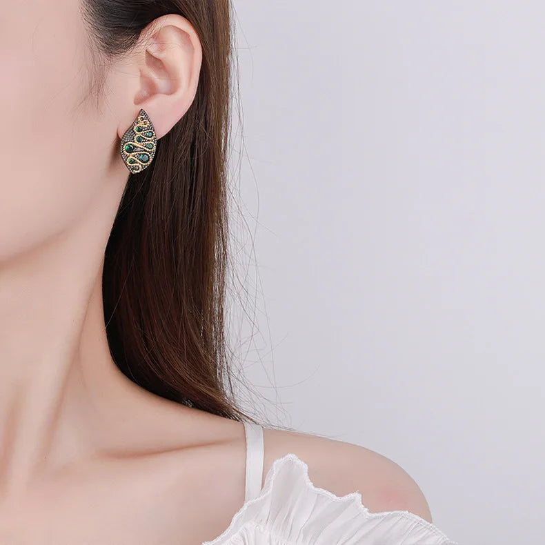 1. Serpentine, Black Gold Style Stud Earrings